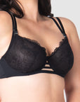 Take a closer look at the True Luxe by Hotmilk Lingerie AU in black, showcasing its contemporary twin strap detailing, semi-sheer full cup coverage, and flexi underwire support. The modern signature magnetic nursing clips and center cutouts elevate this style to the next level of sophistication. Embrace empowerment throughout your breastfeeding journey with this exquisite bra, designed to accommodate cup sizes up to J cup, without making any compromises