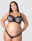 Tiare flaunts Hotmilk's celebrated Temptation nursing and maternity set, showcasing the Temptation Maternity Briefs designed to be worn under the bump. These perfectly match the Temptation Flexiwire Nursing Bra, sheer black lace over nude, a delicate elegance ideal for encapsulating the spirit of maternity photoshoot