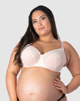 Experience pregnancy confidence with Hotmilk Lingerie's acclaimed award-winning Temptation Nursing and Maternity Bra in Powder. Tiare elegantly showcases size 16/38F, benefiting from wider straps that provide extra lift and support for larger cup sizes. Enjoy all-day comfort throughout pregnancy and the postpartum period