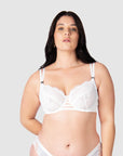 Elevate your style as a bride or wedding guest with Hotmilk Lingerie's True Luxe maternity and nursing bra in crisp white. The twin strap detailing and semi-sheer floral lace add a touch of elegance to this bra, making it the ideal choice for special occasions. The full cup with flexiwire provides support for larger busts, while the plunging center adds a sexy element. Experience the romance and sophistication that Hotmilk Lingerie is known for in this stunning piece